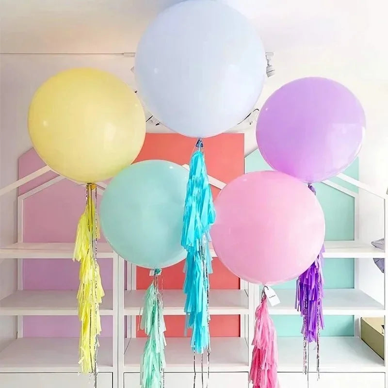 Pastel macaron balloons with paper tassel garland for parties and celebrations.
