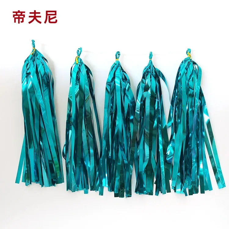 Pastel macaron balloons with paper tassel garland for parties and celebrations.