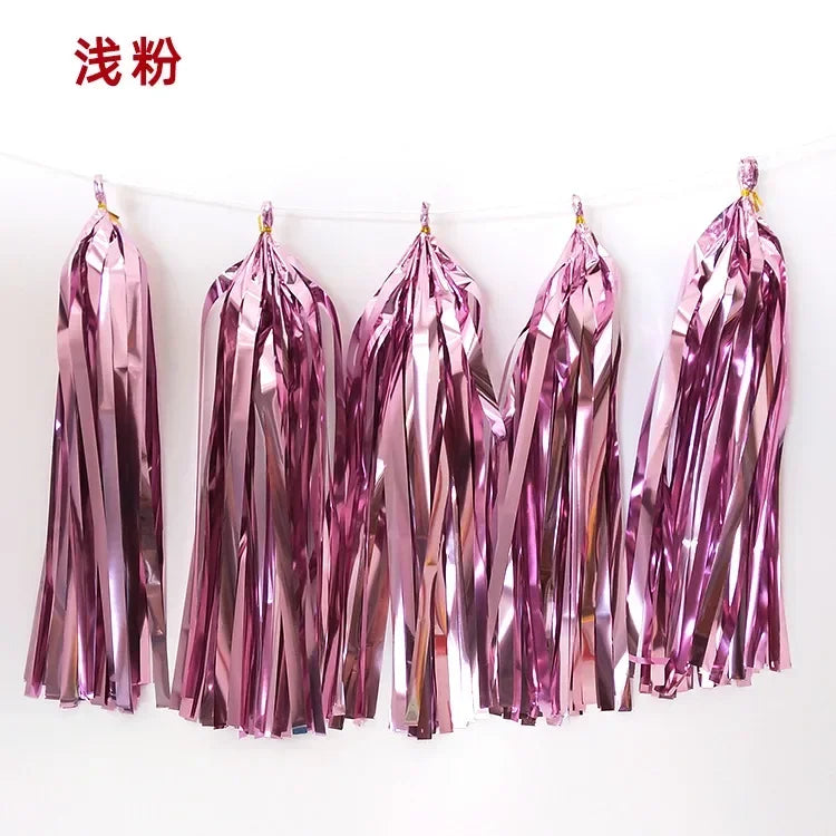 Pastel macaron balloons with paper tassel garland for parties and celebrations.