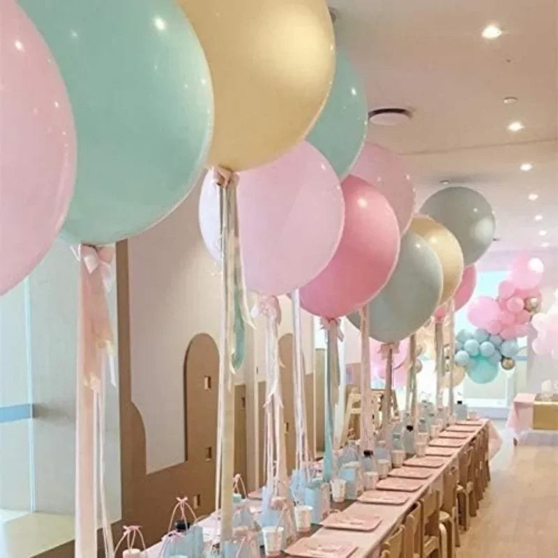 Pastel macaron balloons with paper tassel garland for parties and celebrations.