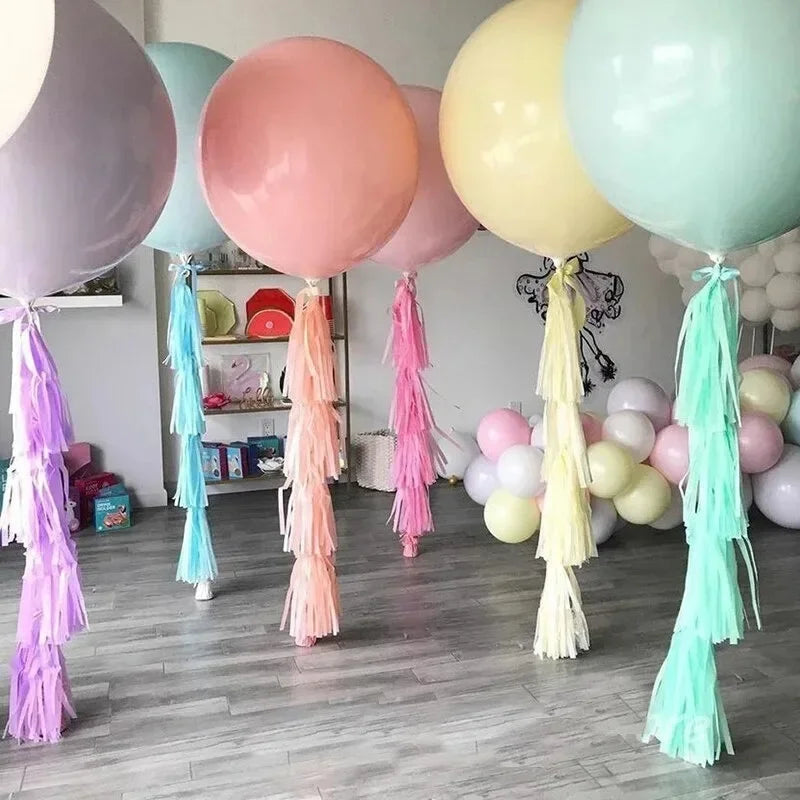 Pastel macaron balloons with paper tassel garland for parties and celebrations.
